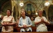 Sisters Audrey Hemsath, left, Theophila Keeven, center, and Viola Marie Spire say prayers after a morning Mass earlier this month in the chapel at the Sisters of the Most Precious Blood in O'Fallon, Mo. The historic order, which has been in the city since 1875, plans to partner with investors and private developers to redevelop its historic 42-acre facility.