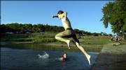 Aaron Sansgaard, 15, jumps into Clinton Lake near the marina after his friend Dustin Illgner, 13, Satruday evening. The Illgner family owns a boat, which they took out for the day at Clinton Lake Saurday, July 15.