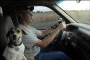 David Badger, who lives south of Carbondale, drives on his family farm along with his dog Missy. Badger's farm is on the end of a lake that supplies the city of Carbondale with it's drinking water, so he's had to change some of his farming habits. He no longer raises hogs because of the sewage runoff.