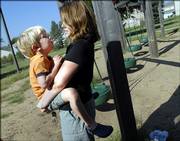 Saasha Huston holds on to her 4-year-old son, Gibson, during an outing Thursday at the playground of Raintree Montessori School. In mid-September, Gibson will undergo brain surgery.