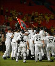 Florida players surround pitcher Anibal Sanchez as they celebrate his no-hitter. Sanchez no-hit the Diamondbacks on Wednesday in Miami.