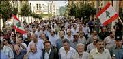 Port workers take part in a protest march against Israel's air and sea blockade of Lebanon, along a route from Beirut's port to the parliament building. Later Wednesday, Israel announced that it would lift the blockade today.