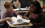 Deena Burnett, an English teacher at West Junior High School, works with eighth-grader Tiana Daniels on how to best write a memoir about something important in her life. Burnett and other teachers hope the Legislature does something to protect the Kansas Public Employees Retirement System, which administers retirement plans for state and local public employees. Currently, there is a gap between the value of KPERS' assets and its future obligations to provide pensions to employees.