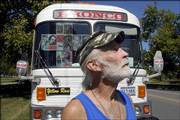 Jim Goodnow, of Terlingua, Texas, stands in front of his silverstreak bus Thursday in South Park. Goodnow is traveling the country collecting signatures to impeach President Bush.