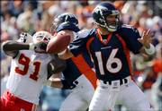 Plummer looks to pass under a rush from Kansas City end Tamba Hali. The Broncos edged the Chiefs, 9-6, Sunday in Denver.