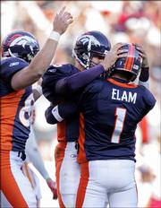 Denver kicker Jason Elam (1) is congratulated by Jake Plummer after Elam kicked a 39-yard, game-winning field goal in overtime.