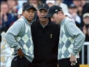 U.S. captain Tom Lehman, center, speaks to Tiger Woods, left, and Jim Furyk on the first tee before the start of play Friday. Woods and Furyk scored a fourball victory against Europe's Colin Montgomerie and Padraig Harrington.