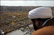 A Shiite Muslim Sheik watches as Hezbollah supporters wave their group&squot;s flags Friday during a Hezbollah "victory" rally, in Beirut&squot;s bombed-out suburbs, Lebanon. Hezbollah&squot;s leader Sheik Hassan Nasrallah made his first public appearance since his group&squot;s war with Israel began July 12, taking the stage Friday before the gigantic rally.