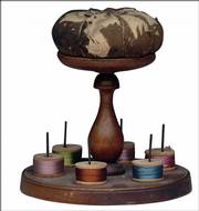 The Shakers, a religious sect that settled in the United States, believed in simplicity. This turned-wood spool holder with a pincushion is 6 inches high.