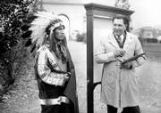 William "Lone Star" Dietz, head football coach of the Haskell Indians, right, starts work on one of his paintings. Louis "Rabbit" Weller, halfback and captain of the Haskell team, left, posed in costume for the painting on Nov. 16, 1931, at the Haskell Institute. Below, Dietz is believed to have drawn this depiction of a Carlisle Indian Industrial School football player in 1910.