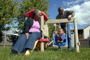 Kathryn and Verner Newman play with their 5-year-old granddaughter, Victoria Newman, Thursday in their backyard. The Newmans are raising Victoria and attend support groups for grandparents who are raising their grandchildren.