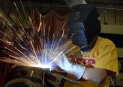 Mark Higgins, 15, a sophomore at Perry-Lecompton High School, throws some sparks as he practices welding last week at school. Many high school graduates will opt for vocational training over a traditional four-year college education, and the state has become highly dependent on this corps of technical professionals.