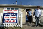 Prospective homebuyers Bill Kimbel, left, and his wife, Joyce, right, leave a condominium with Realtor Susan Bonham, center, near 31st and Kasold streets. "We&squot;re trying to find something we can afford," Joyce Kimbel said on Monday while looking for condos. A new U.S. Census Bureau report says more residences in Lawrence are vacant and that rental prices remain high.