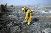 Chula Vista City firefighters check hot spots at the Day Fire near Ojai, Calif., in this Sept. 27 photo. A government official said Tuesday that wildfires in the continental United States burned a record number of acres this year, for a cost of more than $1.5 billion, also a record.