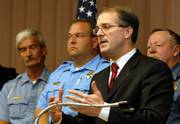 Kansas Atty. Gen. Phill Kline's pursuit of patient records from two abortion clinics has brought criticism from Democrat Paul Morrison, his opponent in the Nov. 7 election. But Morrison wouldn't say Thursday whether he would end the inquiry. Kline is shown Thursday in Pittsburg announcing a $70,000 federal grant to aid in the battle against methamphetamine trafficking in southeastern Kansas.