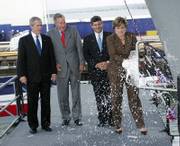 From left, President Bush, his father, former President George H.W. Bush, and Northrop Grumman's Mike Petters watch as Dorothy Bush Koch christens the aircraft carrier George H.W. Bush on Saturday in Newport News, Va. Koch is the daughter of the former president.