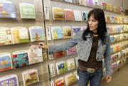 Joan Orth, an art director at Hallmark Cards Inc., checks out the company's line of Sound Cards last month in Kansas City, Mo. Unveiled with a trial run of two dozen designs a year ago, the Say It With Music line expanded to more than 220 cards in July.