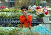 A Kashmiri girl, Hadia Gillani, prays at the grave of her elder brother, who was killed in last year's massive earthquake, during a cemetery in Muzaffarabad, the capital of Pakistani Kashmir. Pakistan's president, Gen. Pervez Musharraf, led a somber memorial service Sunday to mark the first anniversary of the earthquake that killed more than 80,000 people across Pakistan and India.