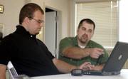 Frank Gossage, 19, Lawrence, receives help on his resume from Matt Enyart, director of support services for ARC of Douglas County. ARC provides support, education and advocacy for people who are developmentally disabled.