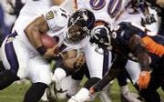 Baltimore running back Jamal Lewis (31) is hit at the line of scrimmage by Denver linebacker Patrick Chukwurah. The Broncos won, 13-3, Monday in Denver.