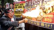 A South Korean protester burns a banner bearing a picture of North Korean leader Kim Jong Il during an anti-North Korea rally Monday in Seoul. North Korea said Monday it performed its first nuclear weapons test. The North&squot;s official Korean Central News Agency said the test was successful, with no leak of radiation, and this was "a stirring time when all the people of the country are making a great leap forward in the building of a great prosperous powerful socialist nation."