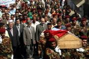 Iraqi soldiers carry the coffin of Gen. Amir al-Hashimi, brother of Vice President Tariq al-Hashimi and an adviser to the Defense Ministry, during his funeral in Baghdad. Al-Hashimi was killed earlier Monday by gunmen who entered his north Baghdad home wearing military uniforms.