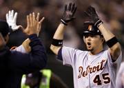Detroit's Alexis Gomez accepts congratulations after hitting a two-run home run against Oakland. The Tigers defeated the Athletics, 8-5, on Wednesday night in Oakland, Calif.
