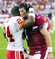 Kansas City's Ty Law, left, hugs Arizona quarterback Matt Leinart. Leinart made his first NFL start Sunday in Glendale, Ariz.