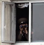 A North Korean soldier observes the South through binoculars in the demilitarized zone at the truce village of Panmunjom. South Korea's military was reportedly readying for a nuclear conflict on Wednesday as the North warned that an international push to level sanctions on Pyongyang over its atomic weapons test would be an act of war.