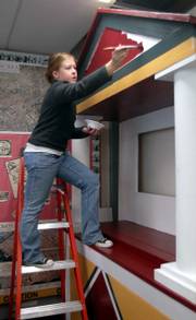 Sydney Seratte, 17, a senior at Lawrence High School and a member of the Latin Club, paints Thursday on a replica of the "House of Vettii," a home of a well-to-do resident of the ancient city of Pompeii.