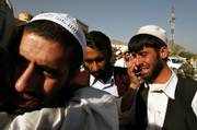 One of 16 Afghans released from the U.S. prison in Guantanamo Bay, Cuba, is hugged by a relative after a ceremony at the Reconciliation Commission in Kabul, Afghanistan. Sixteen Afghans and one Iranian arrived Thursday in Afghanistan, an Afghan official said. The detainees had served up to four years at Guantanamo.