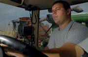 Richard Rachel, of Hoxie, drives a grain truck Friday alongside Hoxie farmer Bill Spillman. Spillman uses both irrigation and dry-land farming methods.