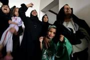 Palestinian relatives of Adel Kdaih and his 14-year-old son, Suhaib, react in the family house Saturday during their funeral in the village of Abbassan near Khan Younis, in the southern Gaza Strip. Twenty Palestinians, most of them militants and including two children, have been killed in a stepped-up Israeli military offensive in the Gaza Strip since Thursday.