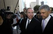 Former Enron CEO Jeff Skilling, left, and his attorney Daniel Petrocelli, right, leave the federal courthouse after Skilling was sentenced to 292 months in federal prison. Skilling was convicted in May of 19 counts of fraud, conspiracy, insider trading and lying to auditors.