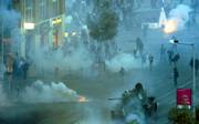 Riot police use tear gas grenades while trying to stop a Russian-made T-34 tank, which was stolen by anti-government protesters from an exhibition of the 1956 revolution, in downtown Budapest, Hungary. Protesters who have been demanding the ouster of the current prime minister disrupted celebrations of the 50th anniversary of the 1956 Hungarian uprising against Soviet occupation.
