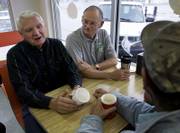 Ken Eberle, left, and Ron Hallagin talk politics as they gather for morning coffee in Ellis. Voters in western Kansas pay attention to the issues and the candidates, but say they feel the needs of the rural part of the state are often ignored.