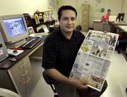 Wintilio Ortiz displays a recent issue of Tiempos, which he publishes from a small office in Wichita. The Spanish-language newspaper covers events both in Wichita and in two states in Mexico to which many immigrants have ties.