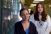 Lawrence High School students Lexie Welch, left, a senior, and Sarah Ybarra, a junior, have raised concerns about the school district policy concerning sending students' names to military recruiters, as required by the No Child Left Behind law. Welch and Ybarra, pictured Thursday at the school, are producing a documentary about the subject.