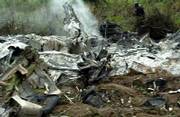 Nigerian police officers walk past some of the debris of an airliner that crashed in Abuja, the capital. The plane crashed in a storm Sunday just after takeoff. Confirmed among the dead in the third fatal crash in less than a year in Nigeria was the man regarded as the spiritual leader of the country's Muslims.