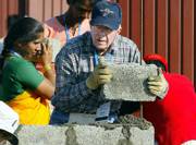 Former U.S. President Jimmy Carter builds a house as part of the 23rd Jimmy Carter project Monday in Patan Village, southeast of Bombay, India. The 23rd Jimmy Carter Work Project will build 100 homes in a week around the world.