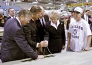 U.S. Secretary of Transportation Mary Peters looks at hydraulic lines in the wing of a Cessna Citation during a a tour of the Wichita production plant with Cessna President, Chairman and CEO Jack Pelton, left; Rep. Todd Tiahrt, R-Kan.; and Sen. Pat Roberts, R-Kan., while production line worker Patrick Medlin looks on Monday.