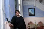 Sharon Surface of the Hutchinson Area Paranormal Investigation group takes a temperature reading inside the Blue Duck Bistro restaurant. Surface said she has performed banishments and had ghosts throw objects at her.