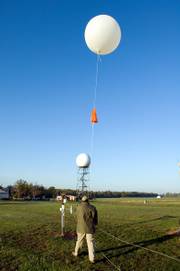 Weather balloons, such as this one about to be released by Calvin Meadows in Sterling, Va., are deployed in 92 locations across the United States. This operation may become obsolete if a network of high-tech sensors installed on some U.S. passenger planes succeeds.