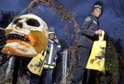 Varian Moore, 7, left, and Christene Coles, 11, trick-or-treat in Davenport, Iowa, on Monday. People are divided on the issue of whether to leave out an unattended bowl of candy for trick-or-treaters on Halloween.