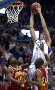 Kansas University's Sasha Kaun dunks over a trio of Pittsburg State players. KU's junior center won't be dunking on anyone for at least the next three weeks as he recovers from a partial tear of the patellar tendon in his right knee.
