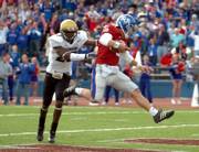 Kansas freshman quarterback Todd Reesing jumps into the end zone as Colorado's Lionel Harris in futile pursuit. Reesing made an impressive collegiate debut Saturday in a 20-15 victory over the Buffaloes.