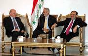 Iraqi Prime Minister Nouri al-Maliki, right, and U.S. national intelligence director John Negroponte, left, meet Friday in Baghdad in this image released by the Iraqi government. The man at center is an unidentified translator.