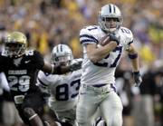Kansas State wide receiver Jordy Nelson sprints for the end zone after catching a pass in the fourth quarter against Colorado. Buffaloes cornerback Cha'pelle Brown and KSU wide receiver Daniel Gonzalez trail on the play. The Wildcats earned a 34-21 victory Saturday in Boulder, Colo., making them bowl eligible for the first time since 2003.