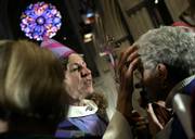 Presiding Bishop of The Episcopal Church Katharine Jefferts Schori, center, blesses a woman following a ceremony in which Jefferts Schori was installed as presiding bishop during a ceremony Saturday at the National Cathedral in Washington, D.C.