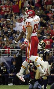 TONY GONZALEZ (88) celebrates with teammate Kris Wilson after scoring the first of his two touchdowns.